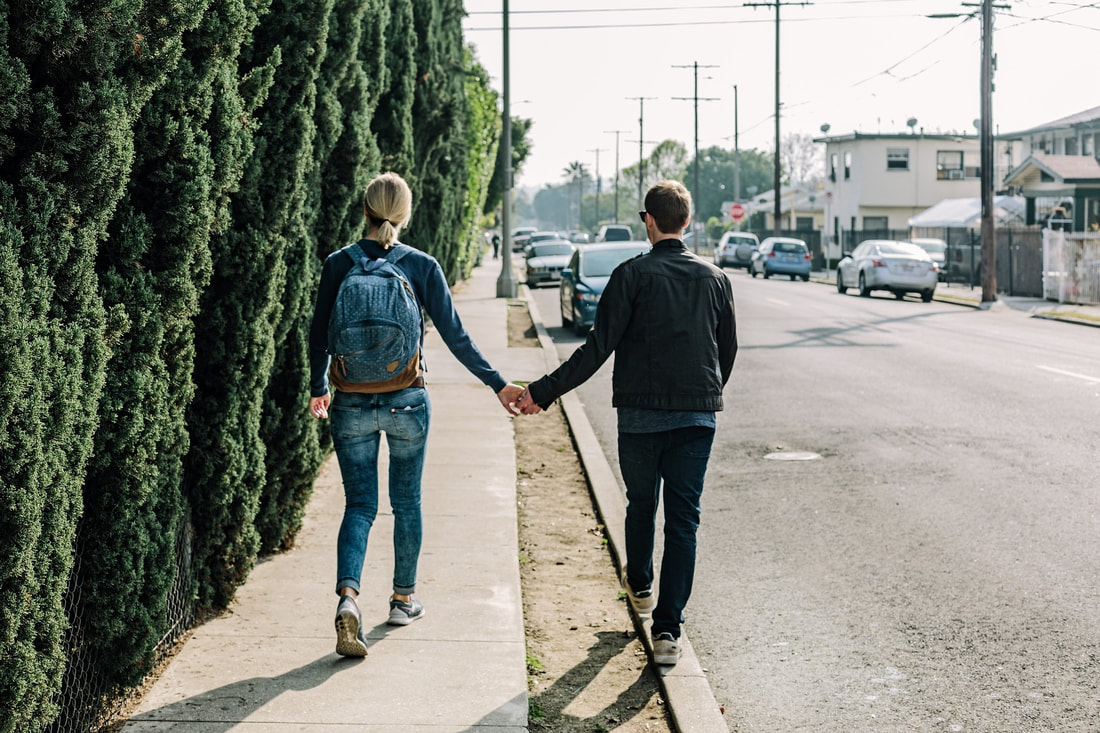man and woman walking holding hands