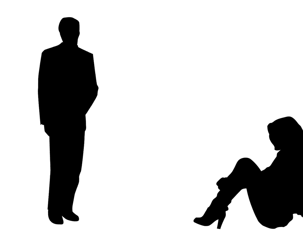 silhouette of man standing, woman sitting on floor
