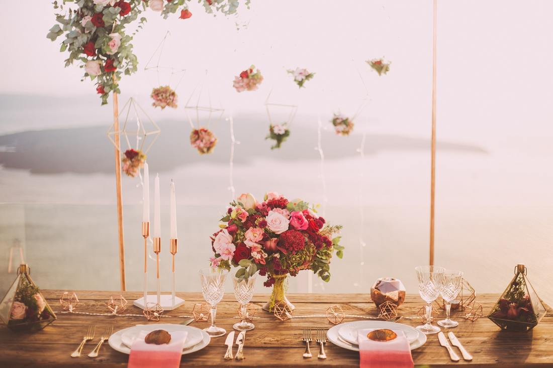 decorated table with red roses and hanging flowers