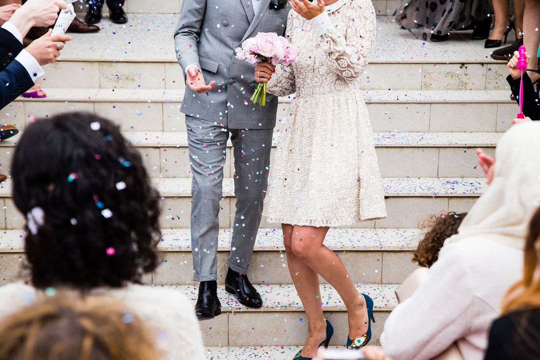 man in grey suit, woman in white dress on their wedding day