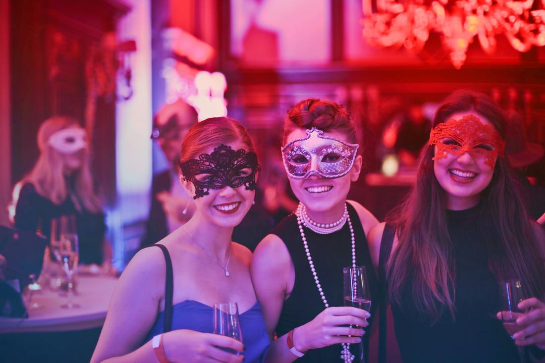 women in masks at a party