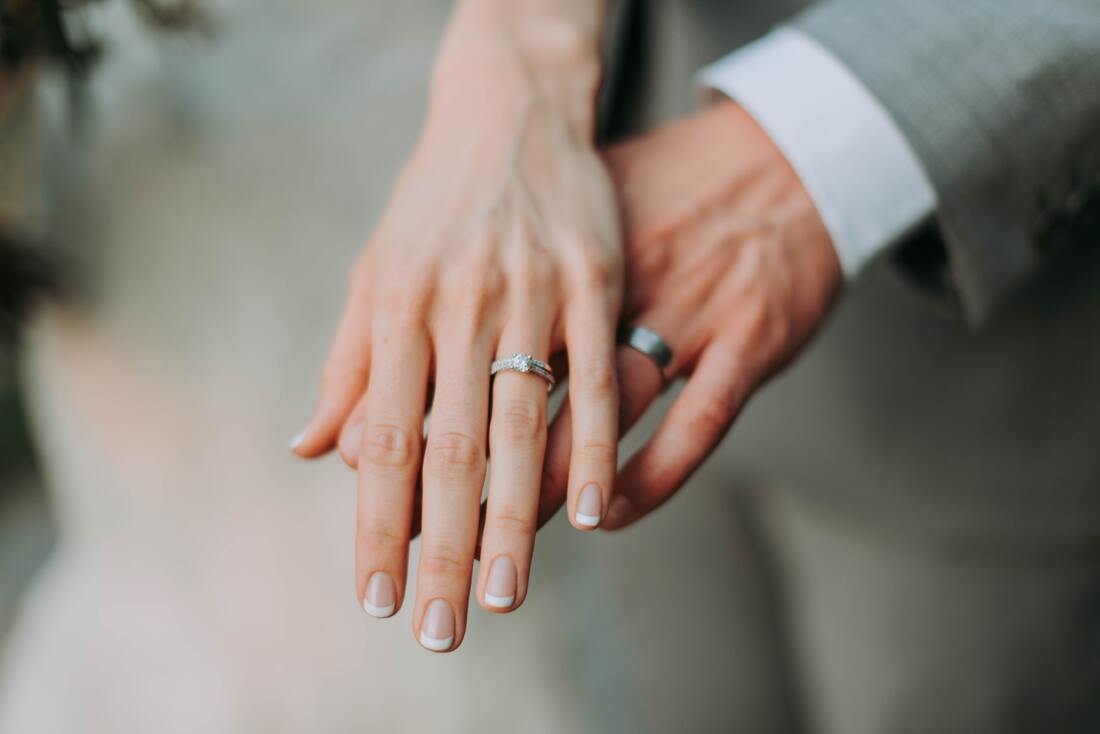 man and woman showing wedding rings