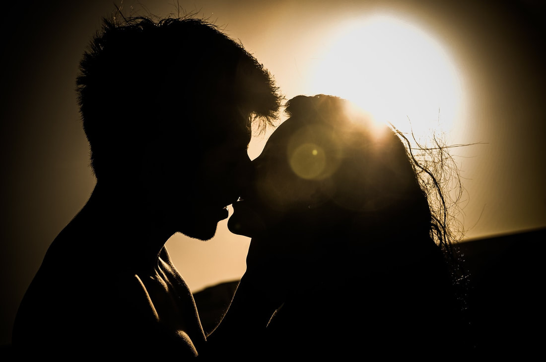 couple kissing sunset