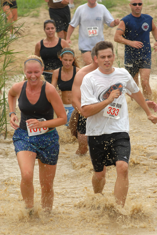 man and woman running race in water